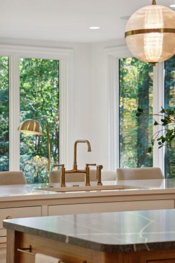 Elevate your culinary experience with stunning gold tone luxury fixtures that add a touch of elegance to this kitchen. These exquisite details not only enhance functionality but also create a sophisticated ambiance, making cooking and entertaining a