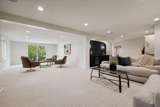 This cozy lower level family room is designed for fun and relaxation, offering a welcoming space ideal for game night. With plenty of room for friends and family, itâs the perfect spot to create lasting memories together!