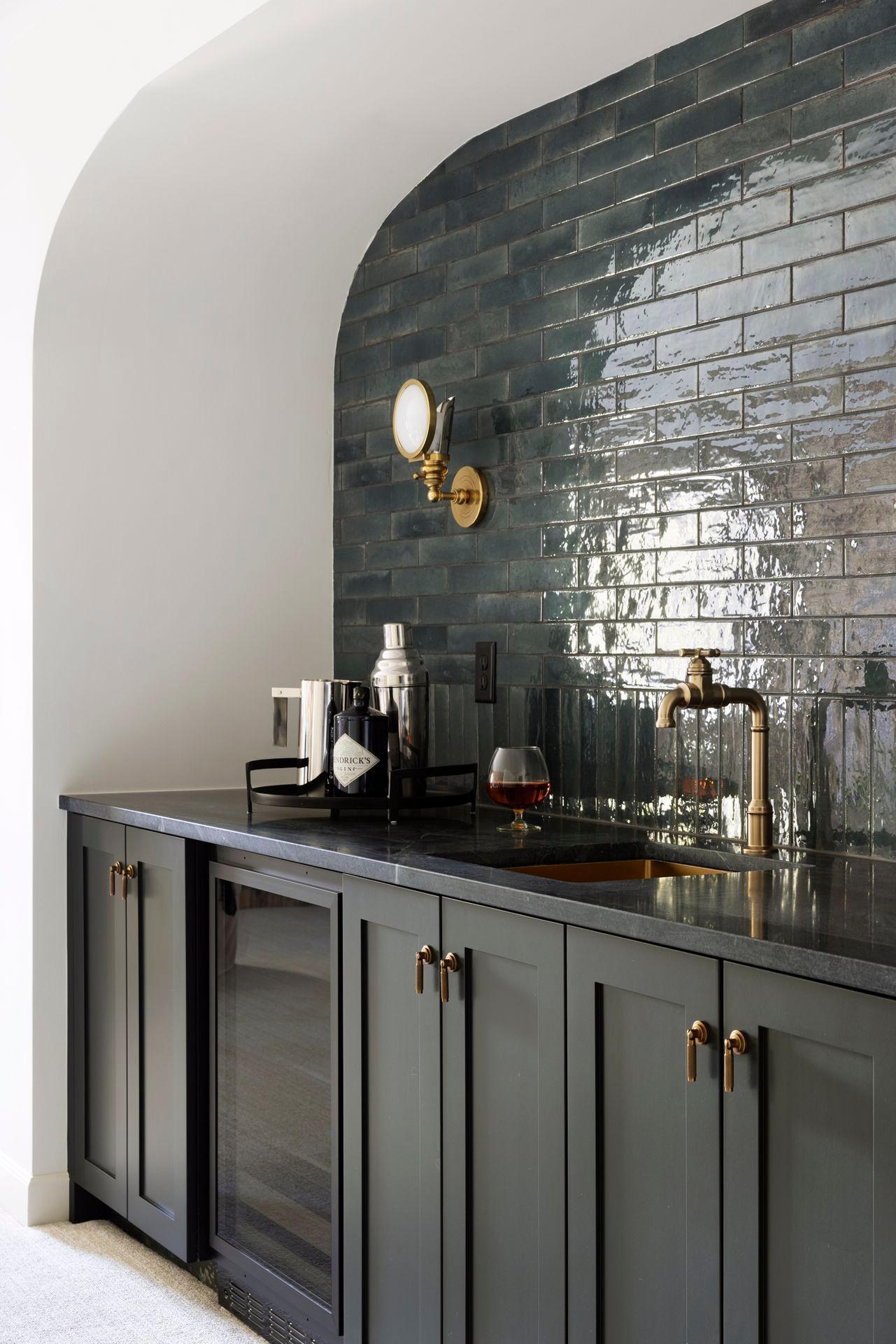 This inviting lower level features stunning original brick accent walls paired with a modern beverage bar. The perfect blend of rustic charm and contemporary style creates a cozy yet stylish space for entertaining or unwinding.