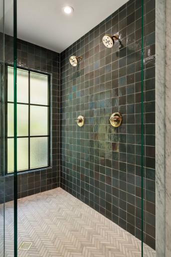 The glazed tile surround in this walk in shower is stunning and the natural light genius in the redesign of this primary bath