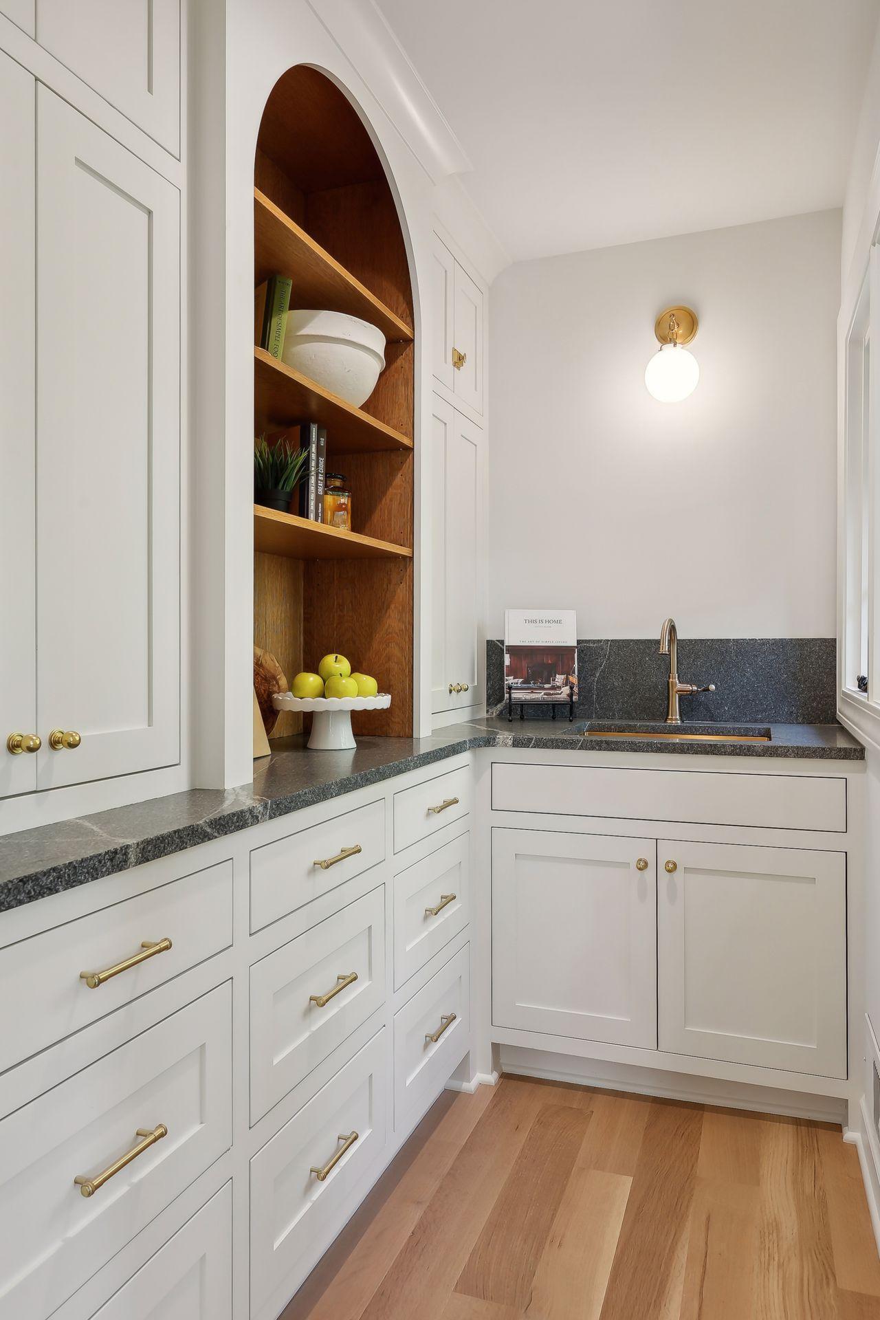 This stylish butler's pantry offers additional storage and prep space, making entertaining a breeze. With its refined design, it enhances the functionality of your kitchen while adding a touch of sophistication to your home.