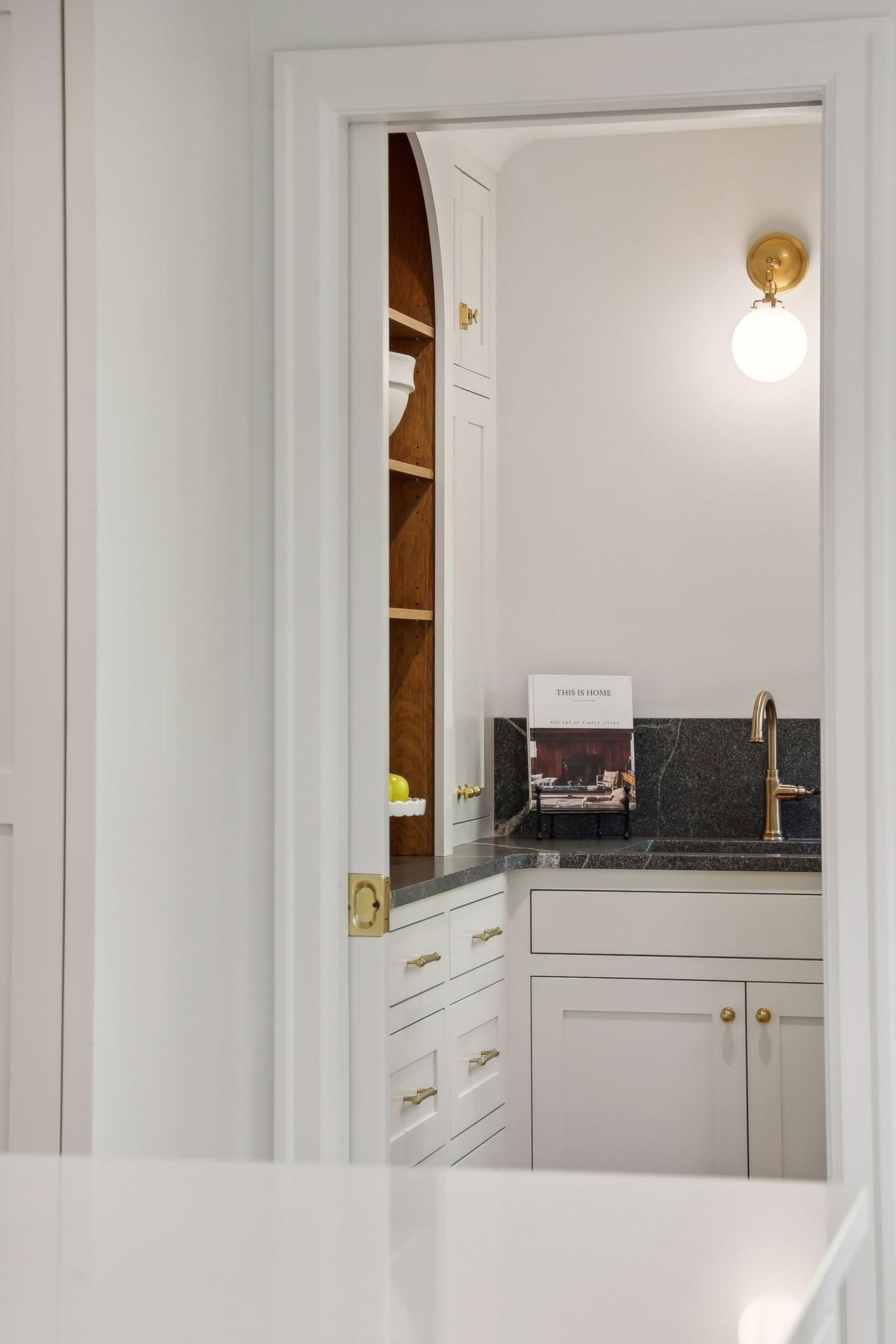 This sophisticated butler's pantry offers additional storage and prep space, making entertaining a breeze.