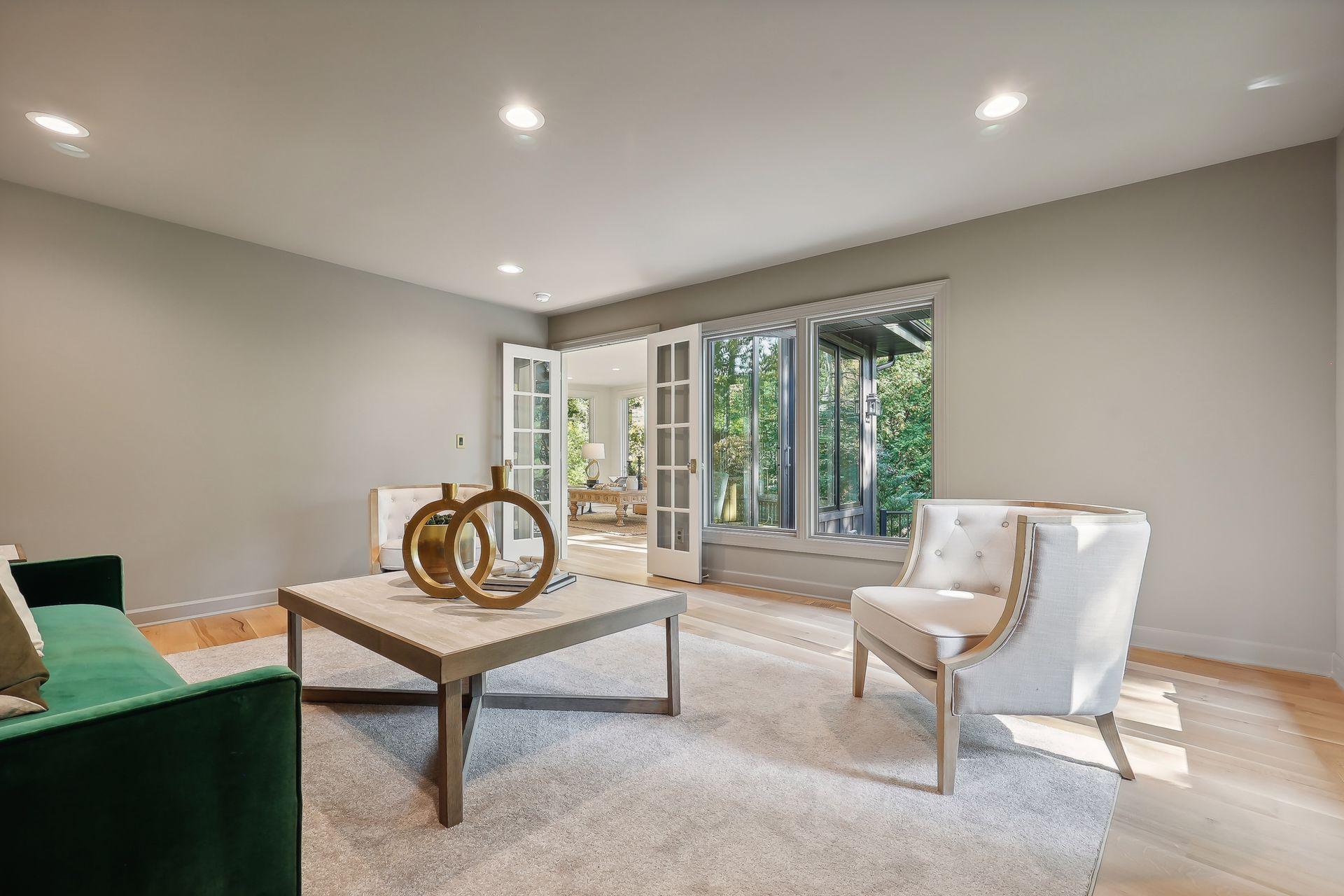 This inviting family room flows seamlessly into a bright 4-season porch, offering panoramic views of the backyard. Perfect for year-round enjoyment, this space enhances your living experience with a tranquil connection to nature.