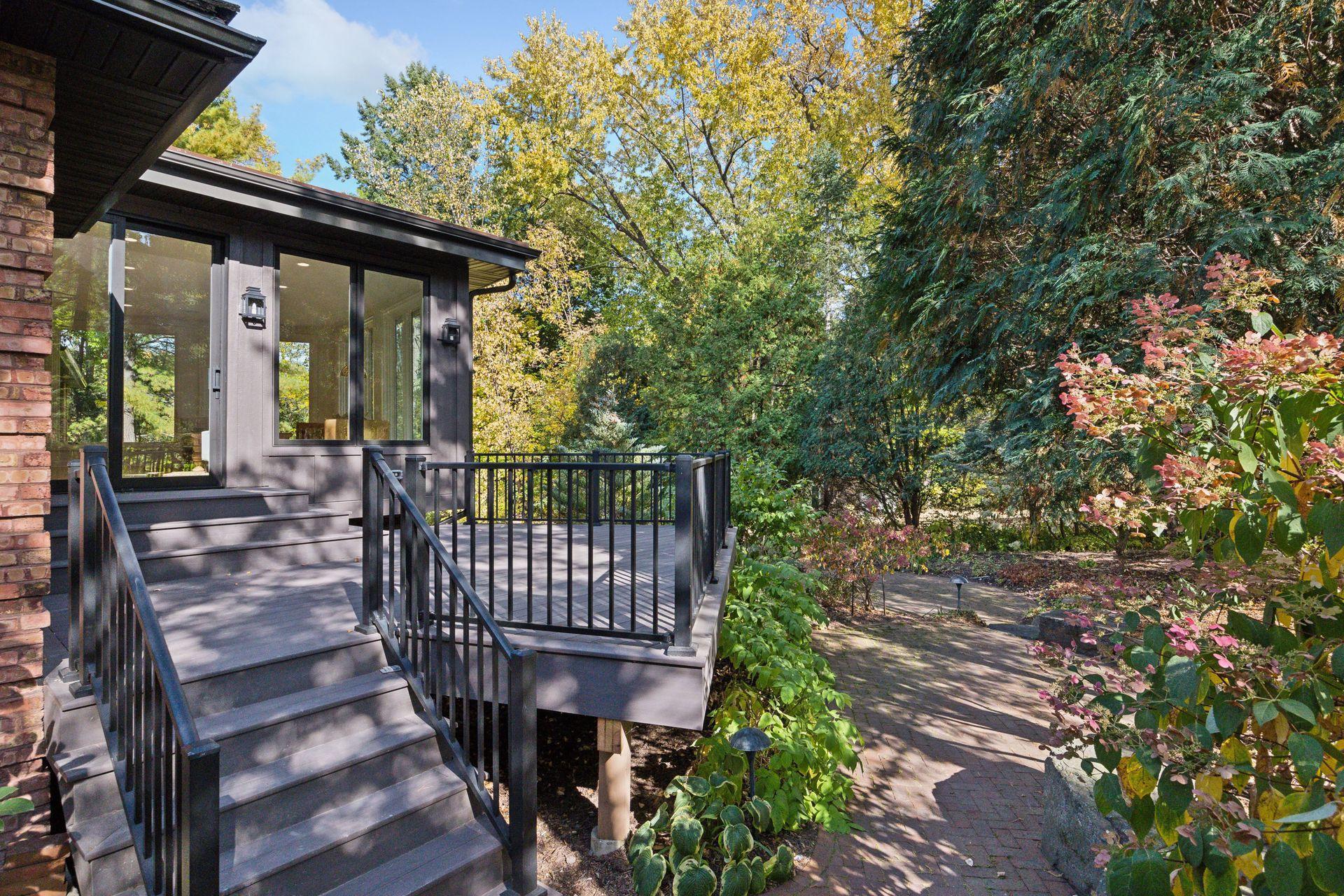 Step onto the deck and be surrounded by lush landscaping that creates a private, tranquil retreat. Ideal for entertaining or unwinding, this inviting space blends seamlessly with the beauty of nature, offering a perfect backdrop for any occasion.