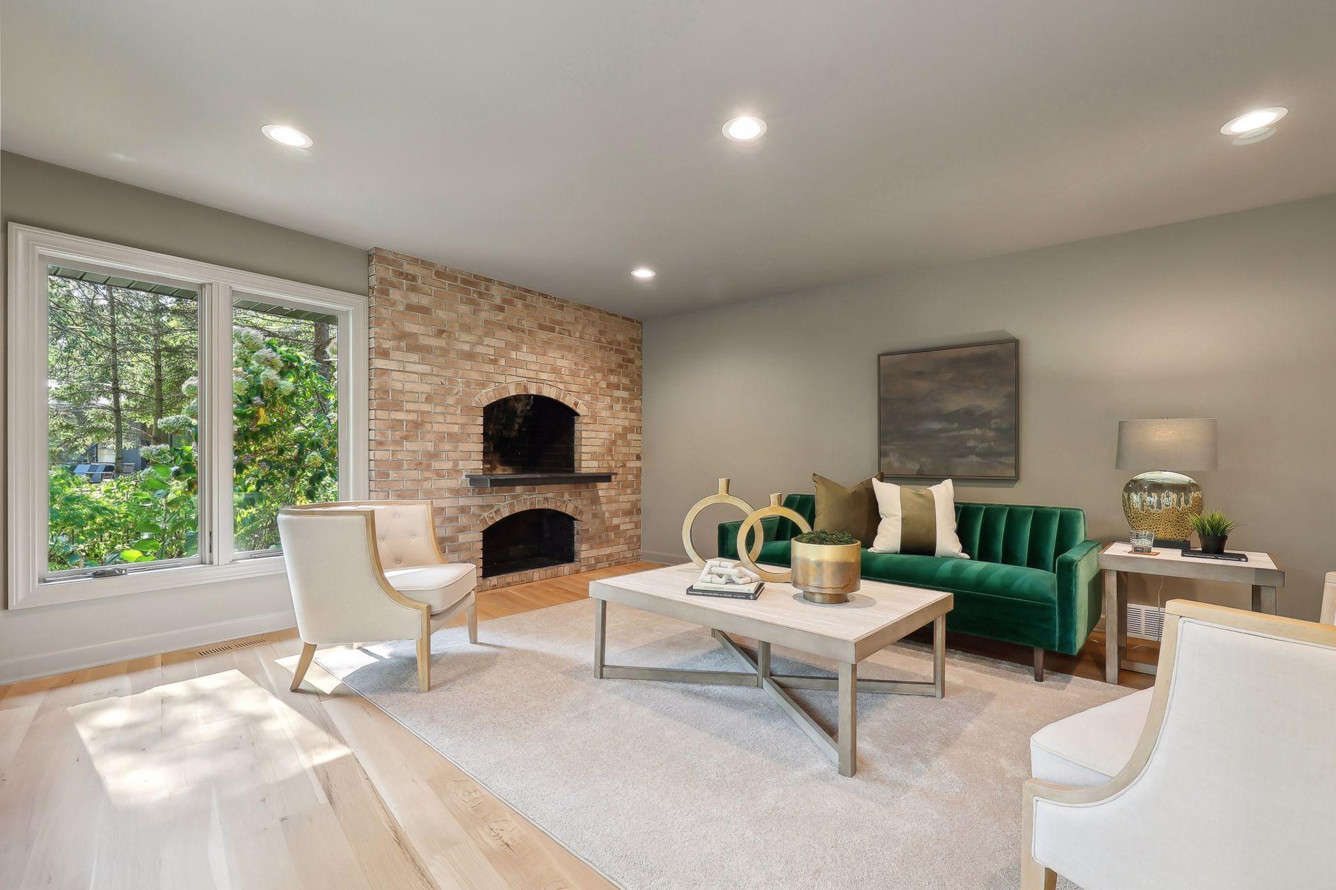 This cozy family room features a stunning preserved stone fireplace, adding warmth and character to the space.