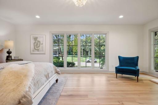 This beautifully designed primary suite is perfectly located on the main level, featuring abundant natural light that enhances the spacious and inviting atmosphere. Experience convenience and tranquility in your personal retreat!