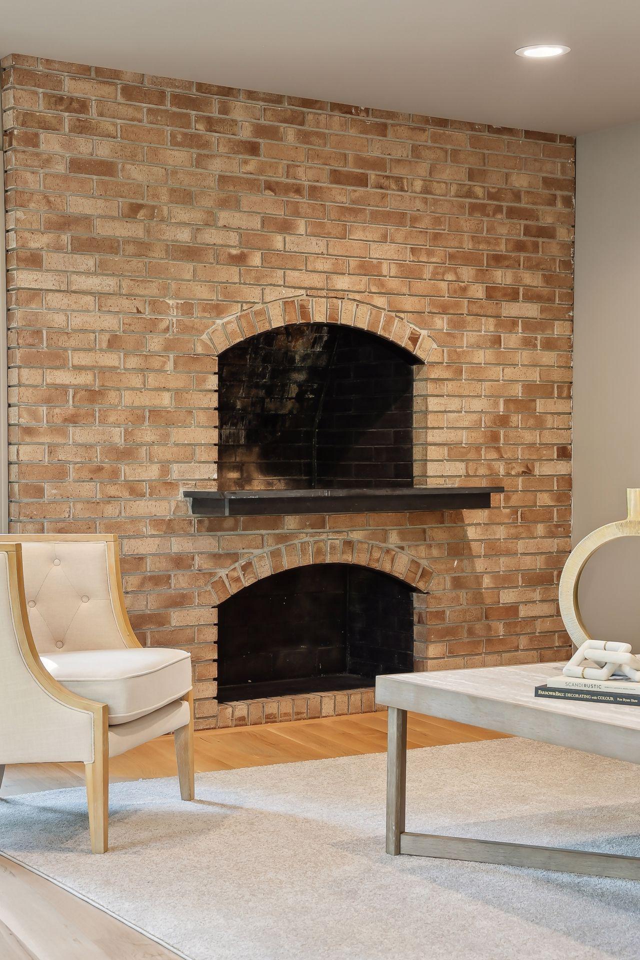 This stunning stone fireplace and mantle have been meticulously preserved, showcasing timeless craftsmanship and character. The perfect centerpiece for your living space, it adds warmth and elegance, creating an inviting atmosphere for gatherings.