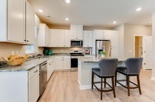 Spacious kitchen with a big window above the sink for beautiful natural light. *Photos of model home, finishes and options will vary.