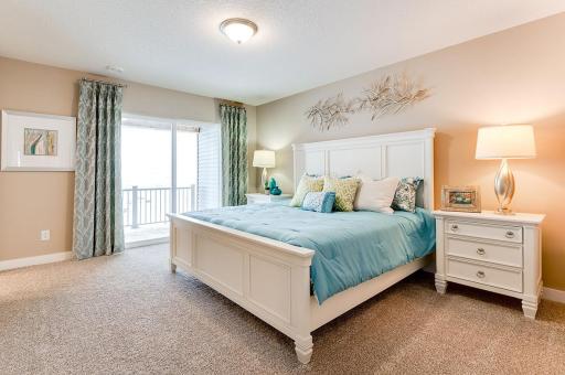 This primary suite is simply amazing! Plenty of room for a king bed and whatever furniture arrangement you can imagine. Plus, a private covered deck! *Photos of model home, finishes and options will vary.