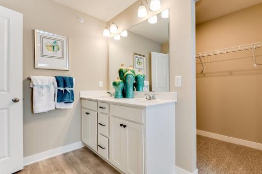 Primary suite includes double vanity sinks with quartz countertop, a huge walk-in closet, and a walk-in shower as well! *Photos of model home, finishes and options will vary.