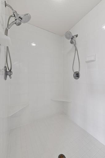 The tiled, walk-in shower features two shower heads.