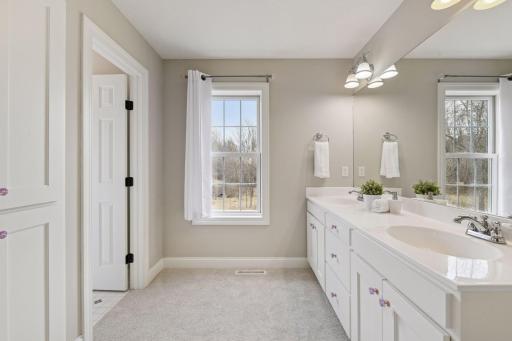 Two of the Bedrooms share a full Jack-and-Jill bathroom with an enameled vanity, linen cabinet and tiled water closet.