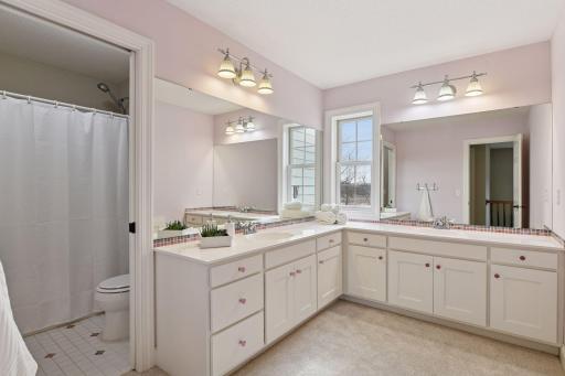 A full Bathroom on the upper level features ample storage and two vanities.
