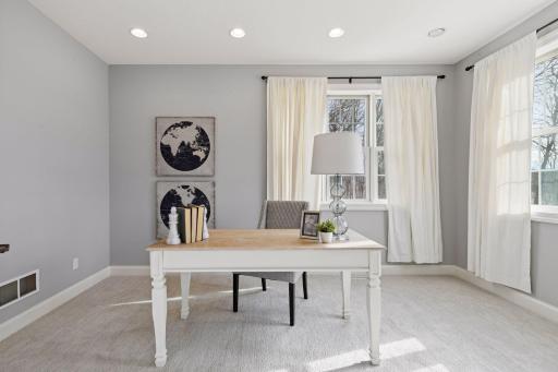 Nestled behind a set of French doors is the Home Office. The space features a storage closet and enjoys long views of the wetlands.