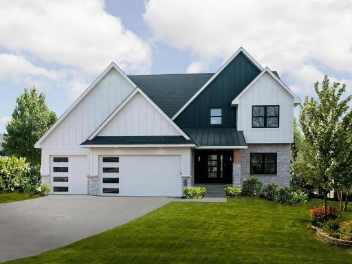 Landscaping with black Anderson windows, cedar soffit under porch and metal roof