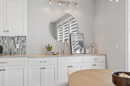 At the end of the kitchen there is a wet bar for the dining area.