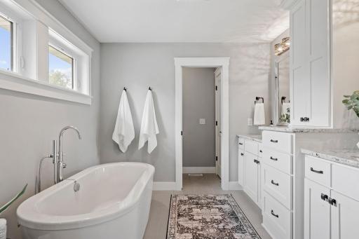 The primary bath has an abundance of storage as well as two separate sink areas.