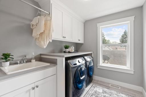 You'll love the spacious upstairs laundry room with storage and folding space as well as a sink on upper level.
