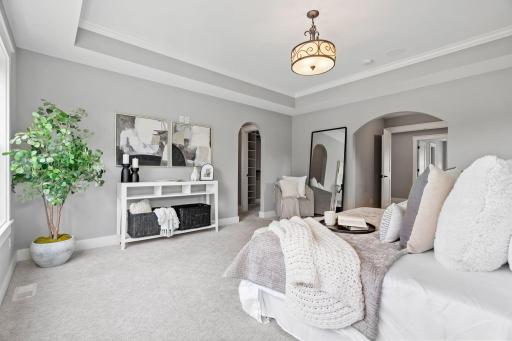 The tray ceiling adds elegance to the primary bedroom.