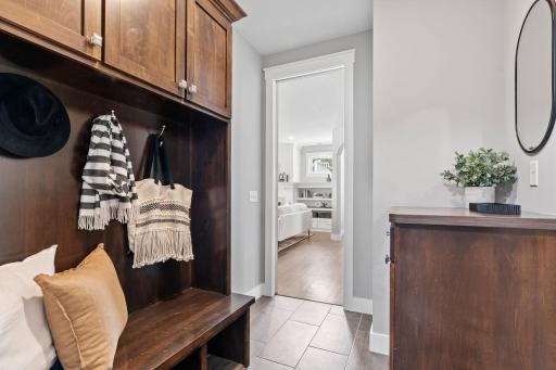 The back entry way with cubbies and hooks for coats, shoes, and bags.