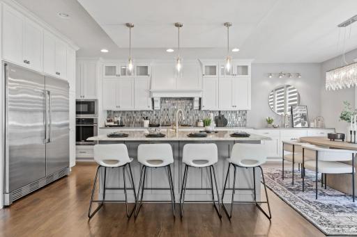 The gourmet kitchen with a large center island complete with breakfast bar.