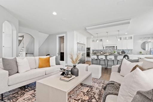 The open floor plan of the living room, kitchen, and dining area.