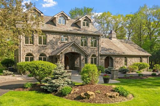 A long tree covered driveway, with stone wrapped pillared lantern lights, loops in front of the house. This stately entrance prepares you for what's to come!