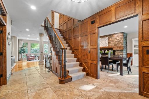 Open dramatic staircase offers oak railings and wrought iron balusters