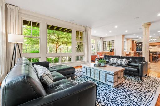 Full glass patio door and floor to ceiling windows offer an abundance of natural light and incredible views of the property