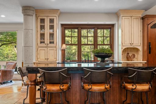 Stunning windows over the sink and full glass patio door with access to the paver patio and property
