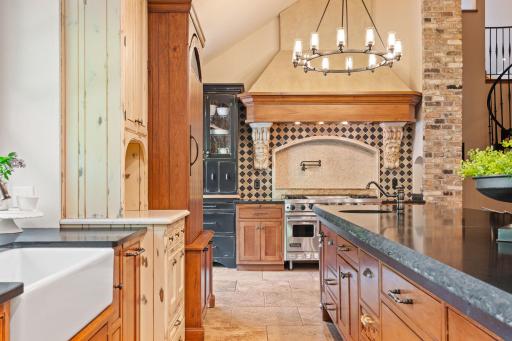 Travertine tile flooring in the Kitchen and rustic walnut flooring in the Informal Dining Room