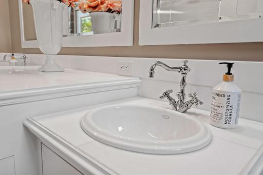 Enameled paneled wainscoting and custom framed mirrors