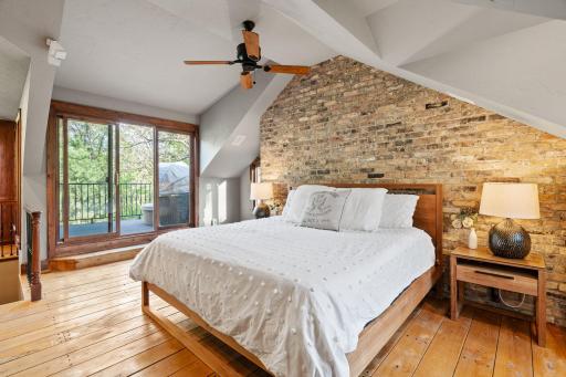 Large windows, full glass entry door leads to private balcony