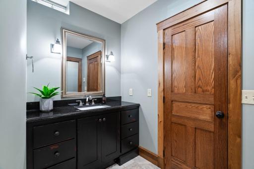 Full Bathroom offers enameled vanity cabinet that includes a wide spread faucet and granite countertop. Travertine tile flooring with radiant in-floor heat.