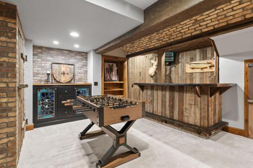 Built-in cabinet with stained glass doors and brick accent wall