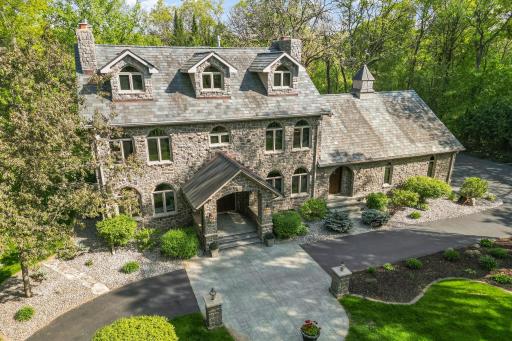 Grand covered entry with cobblestone pillars and wood paneled barrel vaulted ceiling