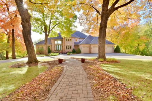 Beautiful 2 story, brick front, walkout basement with circle driveway, 4 car attached, (plus 4 car detached) heated & insulated garages. Mature trees, professionally landscaped, in-ground irrigation, amazing lot just under 6 acres.