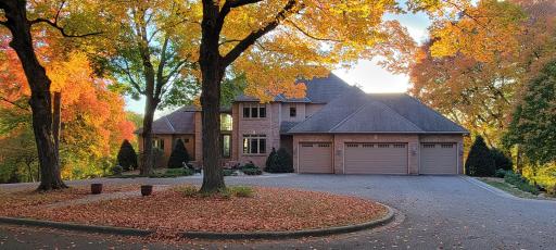 Beautiful 2 story, brick front, walkout basement with circle driveway, 4 car attached, (plus 4 car detached) heated & insulated garages. Mature trees, professionally landscaped, in-ground irrigation, amazing lot just under 6 acres.