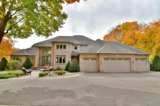 Beautiful 2 story, brick front, walkout basement with circle driveway, 4 car attached, (plus 4 car detached) heated & insulated garages. Mature trees, professionally landscaped, in-ground irrigation, amazing lot just under 6 acres.