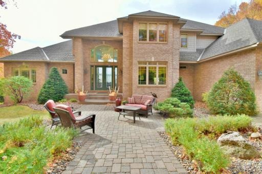 Professionally landscaped, front paver patio entry leading to a gracious, open vaulted entry.