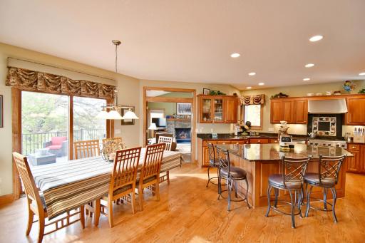 Open concept, large kitchen space with giant granite island, informal eat in kitchen. Sliding door leads out to new maintenance free deck, also neighbors spacious & cozy family room with wood burning fireplace.