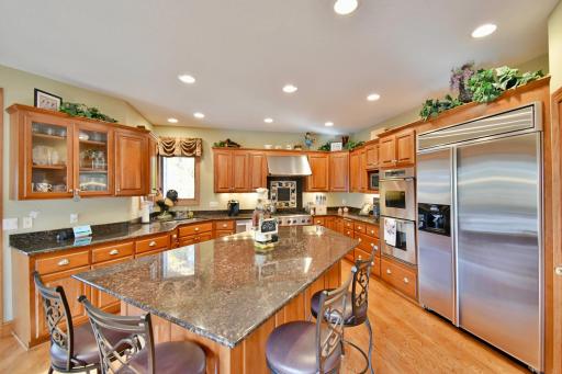 Open concept, large kitchen space with giant granite island, informal eat in kitchen. Commercial grade stainless steel appliances, 6 burner gas stove, double oven, fan/hood exhaust