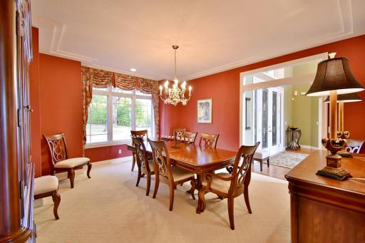 Formal dining area off of front entry overlooking stately front circle driveway, roasted red pepper decor, racetrack ceiling, wonderful space for entertaining & holiday gatherings!