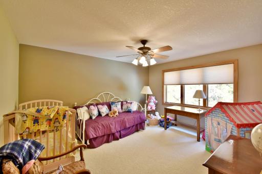 Upstairs bedroom with custom blinds and neutral decor.