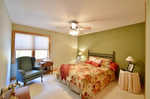 Upstairs bedroom with custom blinds and neutral decor.