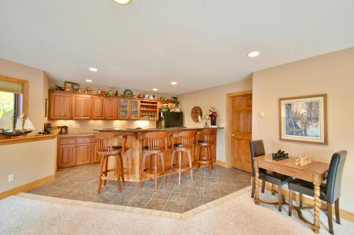 Walkout basement views, wet bar & game room area, neighboring kitchenette room and mechanical room.