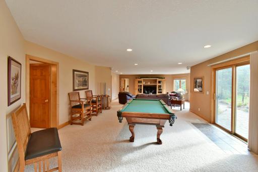 Looking away from gaming & bar area towards billiards table, slider walkout to back paver patio.