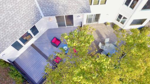 Aerial drone shot of new maintenance free deck and lower level paver patio.