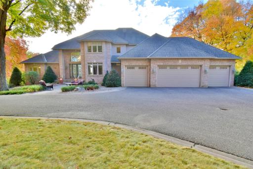 Front of home & circle driveway, 4 car attached, heated and insulated garage with additional seperate 4 car detached heated & insulated garage.
