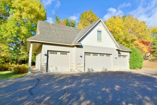 Four car detached garage, heated & insulated, floor drains, finished man cave spaces upstairs, wired for welding, open extra wide driveway, outside hook up for pressure sprayer.
